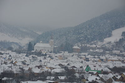 Aerial view of townscape against sky during winter