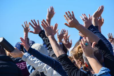 Protestors with hands raised at a protest music festival 