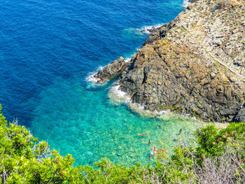 High angle view of rocks by sea