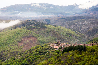 High angle view of townscape by mountains