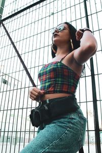 Low angle view of woman standing against window