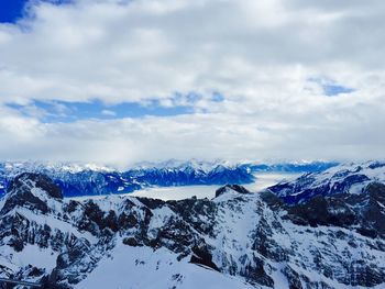 Scenic view of mountains against cloudy sky