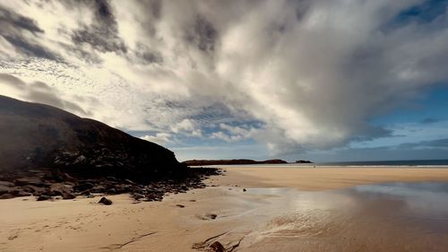 Scenic view of beach against sky during sunset