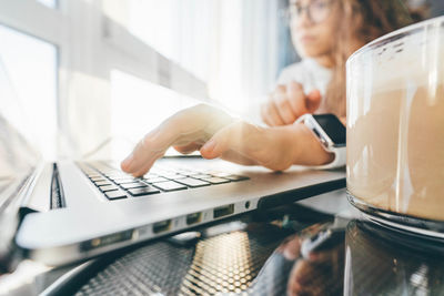 Midsection of woman using laptop