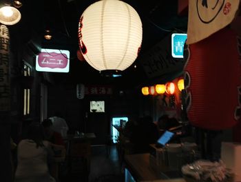 Illuminated lanterns hanging in city at night