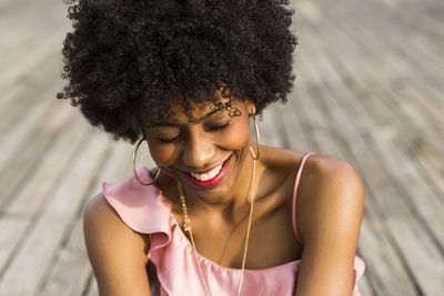 Young woman smiling on boardwalk