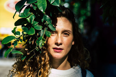 Portrait of beautiful young woman with leaves