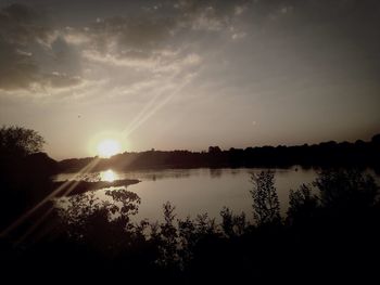 Scenic view of lake at sunset