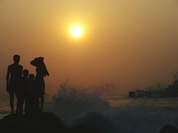 People on beach at sunset