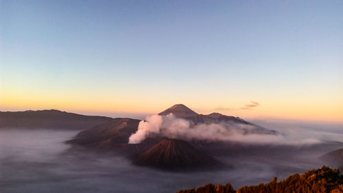 View of volcanic landscape against sky during sunset