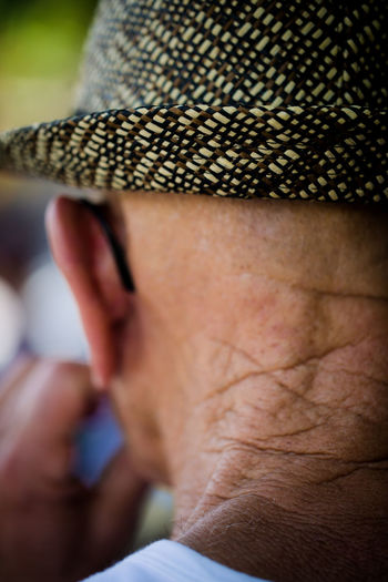 Close-up of man wearing sun hat