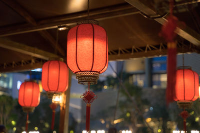 Low angle view of illuminated lanterns hanging from ceiling