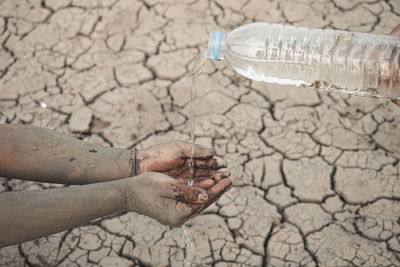 Close-up of human hand on land