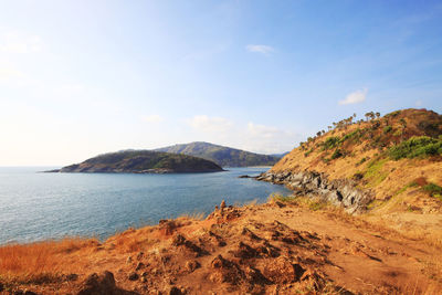 Scenic view of sea and mountains against sky