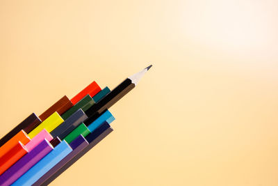 High angle view of colored pencils against white background