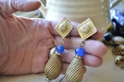 Close-up of hand holding earrings