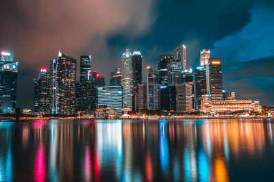 Illuminated buildings against sky at night