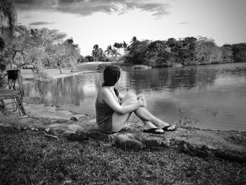 Full length of woman standing by lake