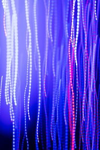 Close-up of illuminated lighting equipment against black background