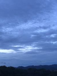 Scenic view of silhouette mountains against sky at dusk