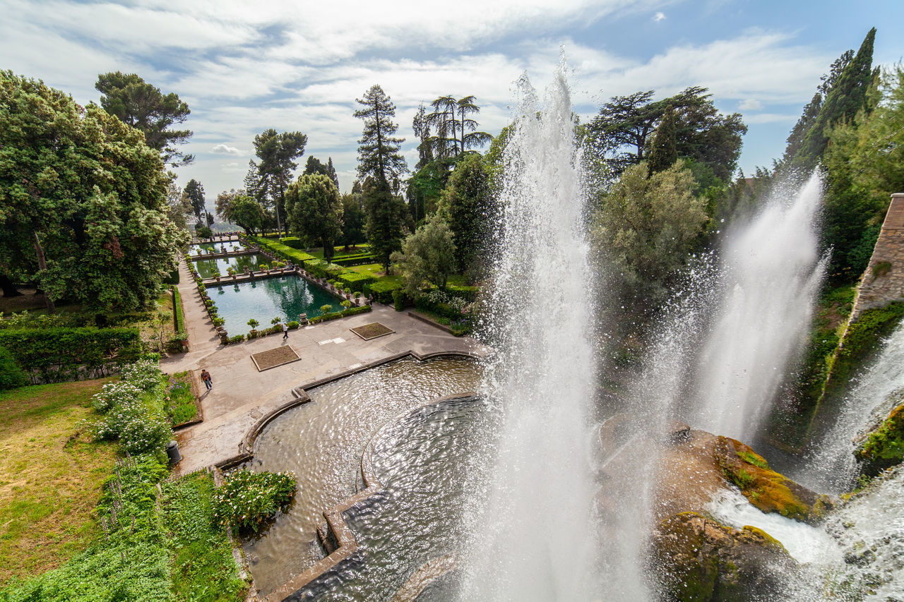 water, waterfall, plant, tree, scenics - nature, nature, body of water, motion, beauty in nature, water feature, environment, cloud, travel destinations, sky, architecture, long exposure, splashing, travel, no people, outdoors, landscape, land, tourism, flowing water, day, forest, built structure, rock, watercourse, sports, park, spraying, power in nature, blurred motion, sea, non-urban scene, fountain