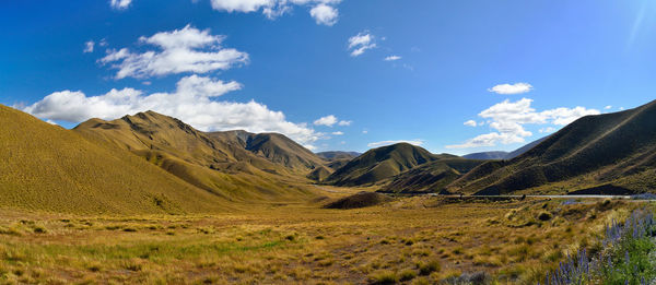 Scenic view of mountains against blue sky