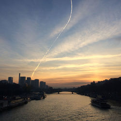 Scenic view of river against sky during sunset