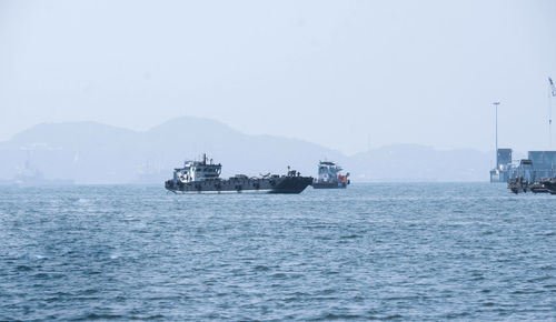 Ship sailing on sea against clear sky