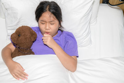 Young woman sleeping on bed