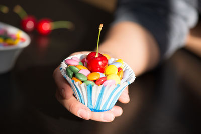 Close-up of hand holding multi colored candies