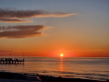 Scenic view of sea against orange sky