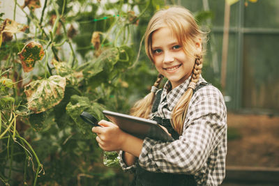 Portrait of a smiling young woman standing outdoors