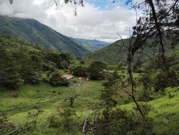 Scenic view of mountains against cloudy sky