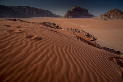 Sand dune in desert against sky