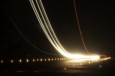 Illuminated light trails on road at night