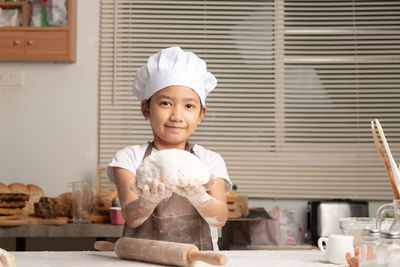 Portrait of smiling girl sitting on table