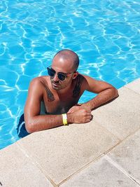 High angle portrait of woman swimming in pool