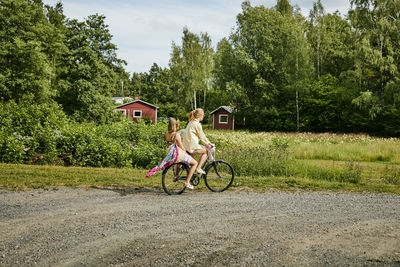 Two friends riding bicycle