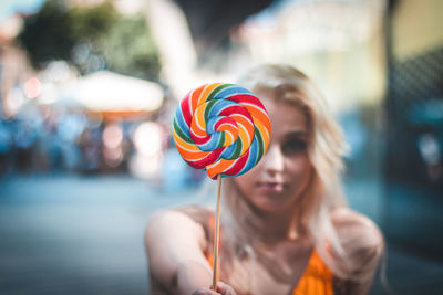 Midsection of woman holding colorful candies