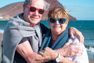 Portrait of smiling woman with sunglasses on water