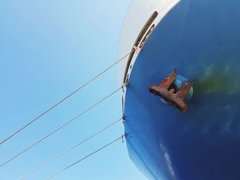 Low angle view of sailboat against clear blue sky