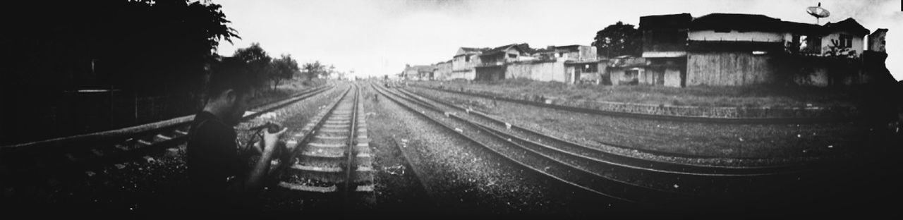 transportation, railroad track, rail transportation, the way forward, diminishing perspective, built structure, vanishing point, mode of transport, architecture, building exterior, sky, outdoors, no people, train - vehicle, land vehicle, public transportation, high angle view, tree, travel, train