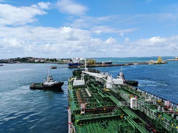 High angle view of ship moored at harbor against sky