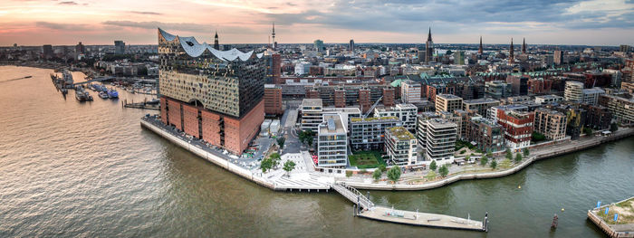 Aerial view of city against cloudy sky