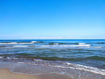 Scenic view of sea against clear blue sky