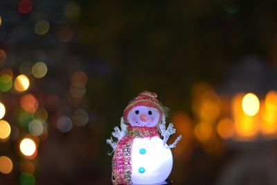 Close-up of illuminated christmas decorations in park during winter