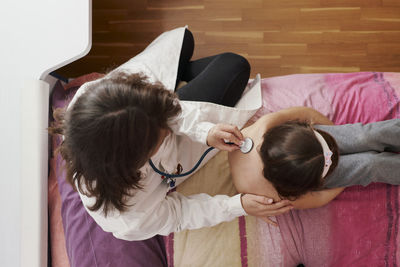 High angle view of mother and daughter at home