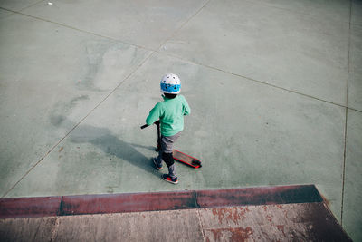 Boy playing with push scooter