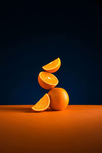 Close-up of orange fruit against blue background