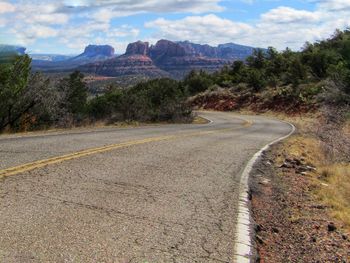 Road amidst arizona landscape against sky